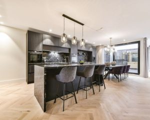 a kitchen with a center island and bar stools.