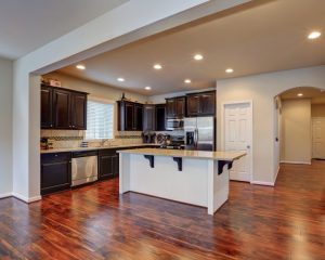 a large kitchen with a center island in the middle of the room.
