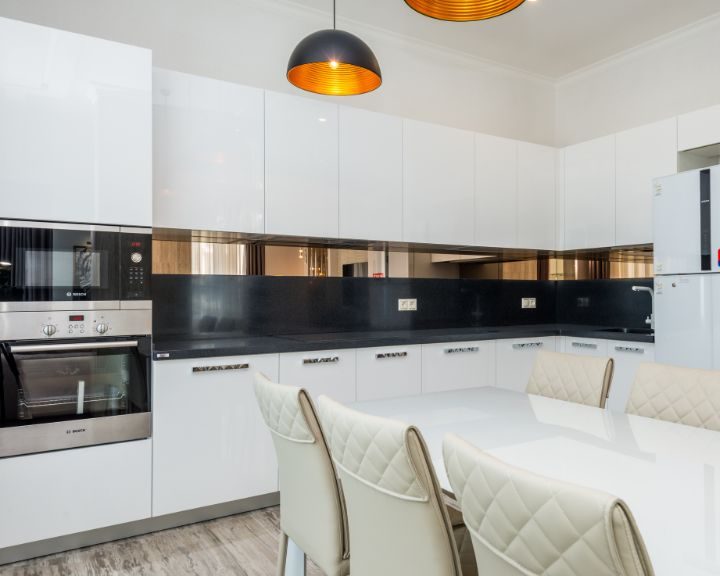 a kitchen with a table and chairs and a stove.