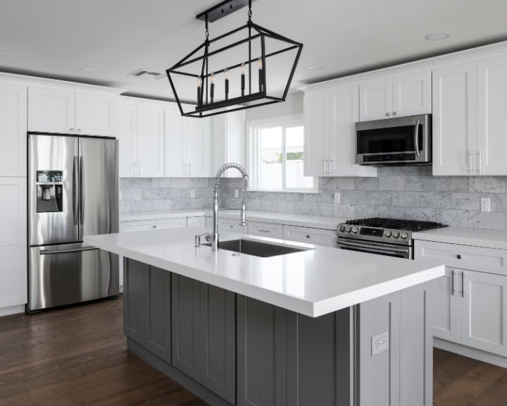 a large kitchen with a center island and stainless steel appliances.