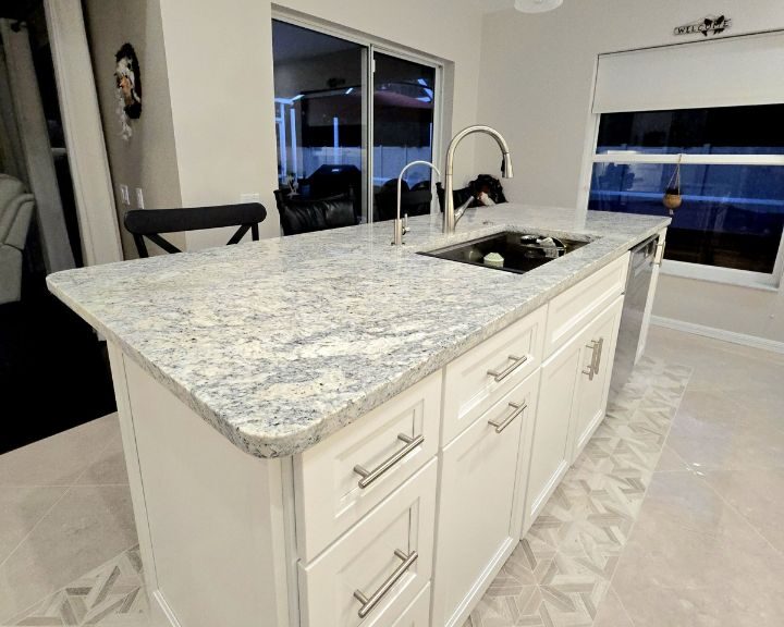 Modern kitchen island with granite countertop and sink