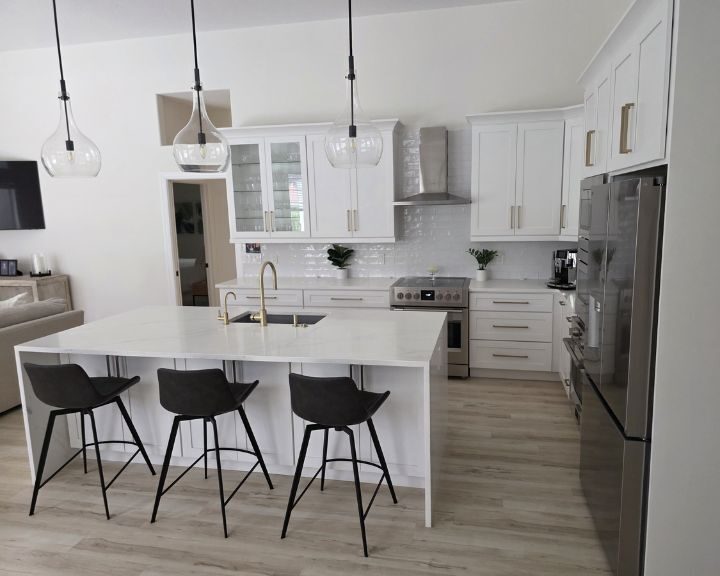 Modern white kitchen with island and bar stools