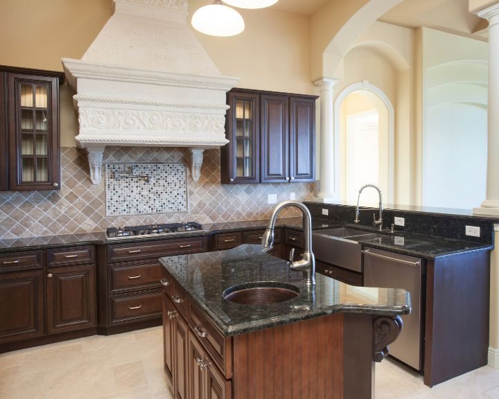 a kitchen with a stove, sink, cabinets and a dishwasher.