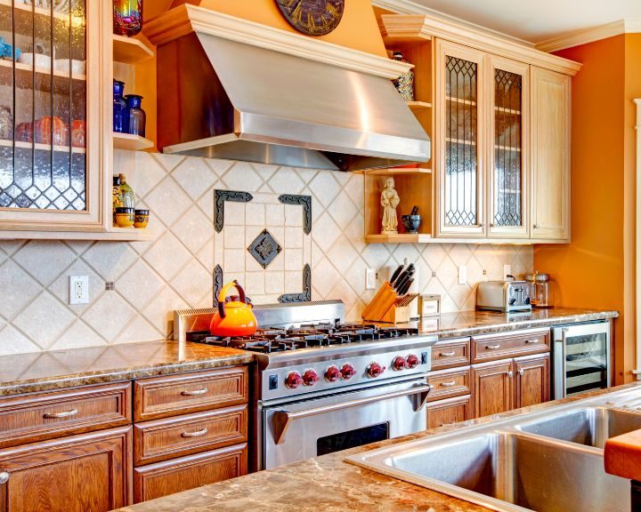 a kitchen with a stove top oven and a sink.